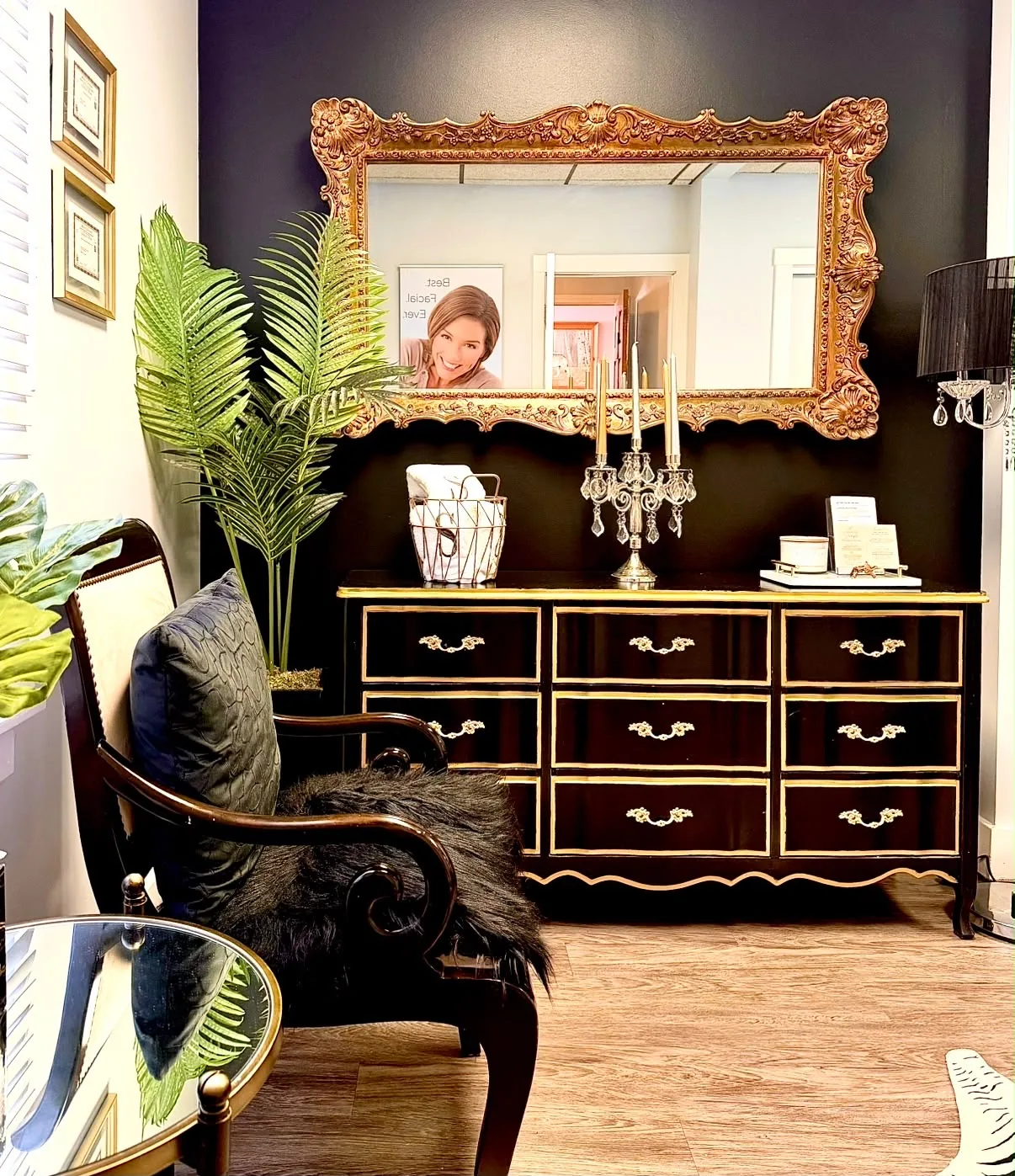 Inside the Silky Smooth Waxing Studio, with ornate gold mirror and black-and-gold furnishings